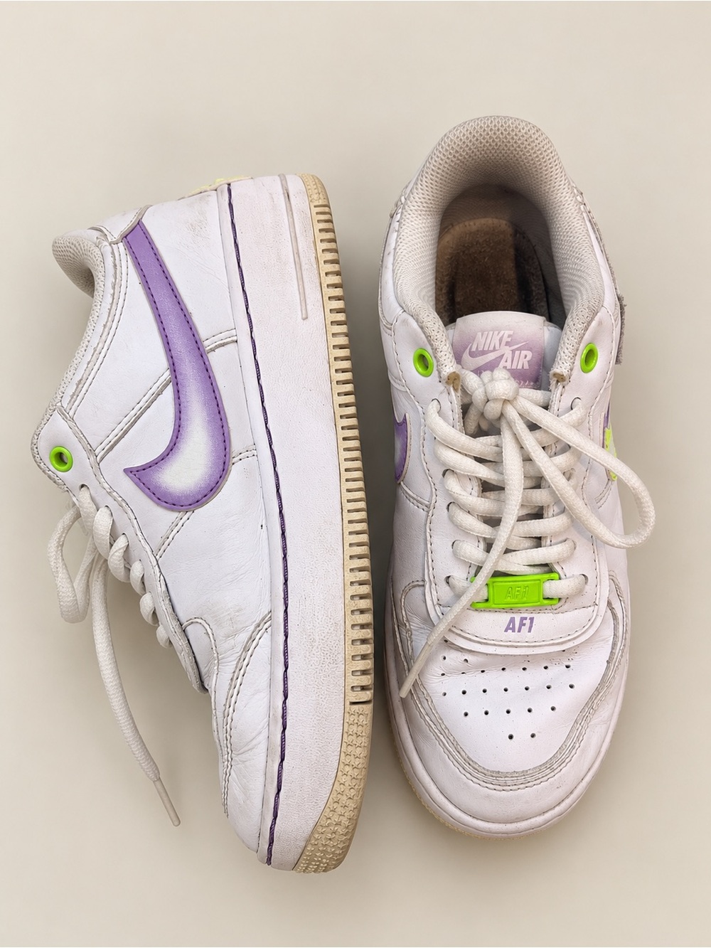 Nike Kids White Sneakers with Purple Swoosh and Neon Green Accents